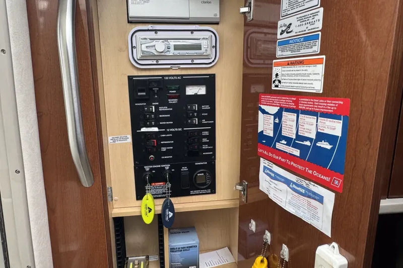 Slide: The Image of Control panel of a 2008 Sea Ray 290 Sundancer boat with safety notices. - 17