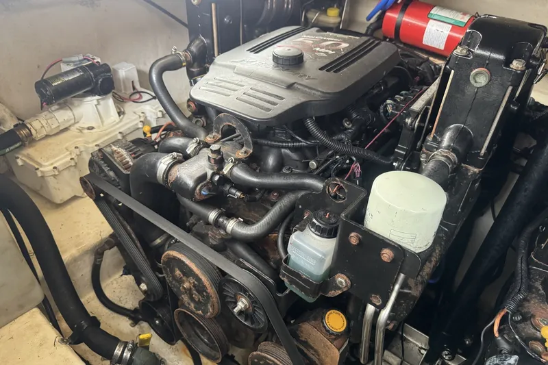 Slide: The Image of Engine compartment of a 2008 Sea Ray 290 Sundancer boat, showcasing mechanical components. - 19