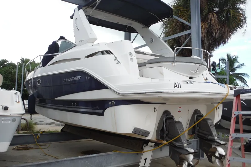 Slide: The Image of 2007 Monterey 330 Sport Yacht on a lift, featuring dual propellers and sleek design. - 1