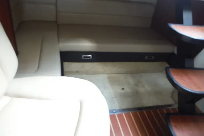 Slide: The Image of Interior of 2007 Monterey 330 Sport Yacht with beige seating and wooden accents. - 26