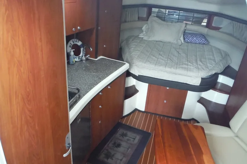 Slide: The Image of Interior of 2007 Monterey 330 Sport Yacht with cozy bed and kitchenette. - 21