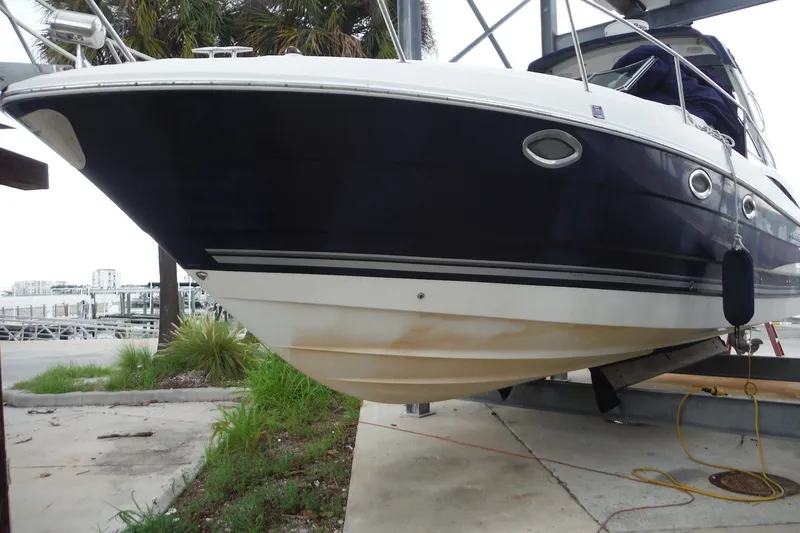 Slide: The Image of 2007 Monterey 330 Sport Yacht on dry dock, showcasing sleek design and hull details. - 5