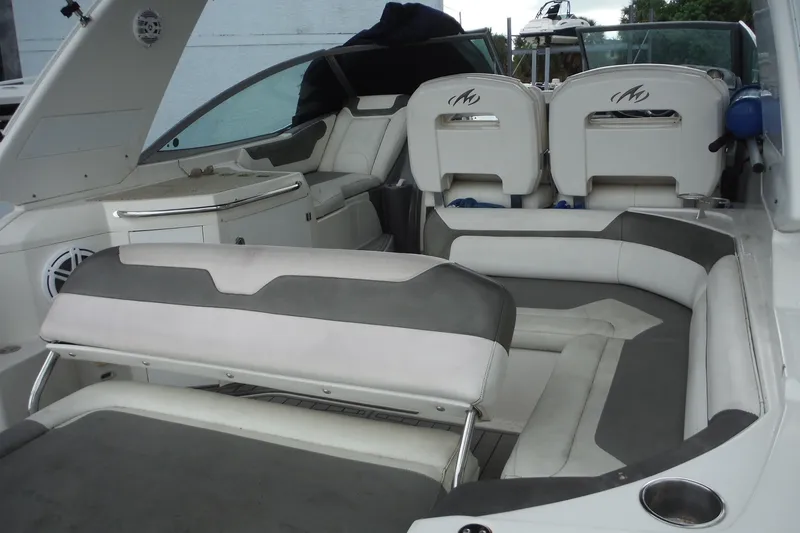 Slide: The Image of 2007 Monterey 330 Sport Yacht interior with white and gray seating, showcasing luxury design. - 9