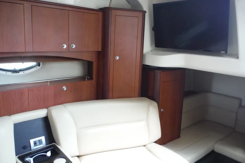 Slide: The Image of Interior of 2007 Monterey 330 Sport Yacht with wood cabinets and beige seating. - 28