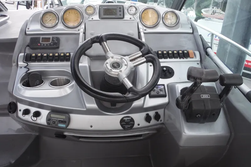 Slide: The Image of 2007 Monterey 330 Sport Yacht dashboard with steering wheel and control panel. - 10