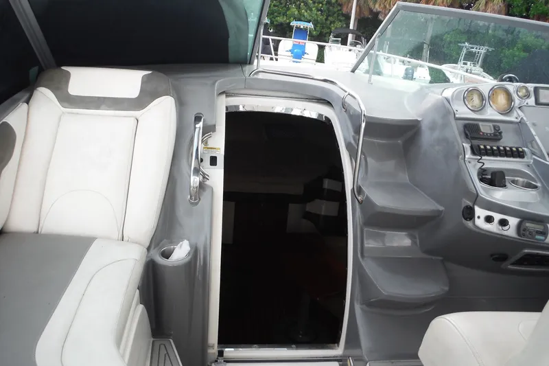 Slide: The Image of 2007 Monterey 330 Sport Yacht cockpit with seating, helm, and cabin entrance. - 12