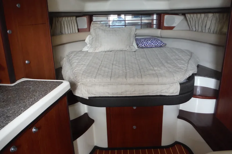 Slide: The Image of Interior cabin of 2007 Monterey 330 Sport Yacht with cozy bed and wooden accents. - 22