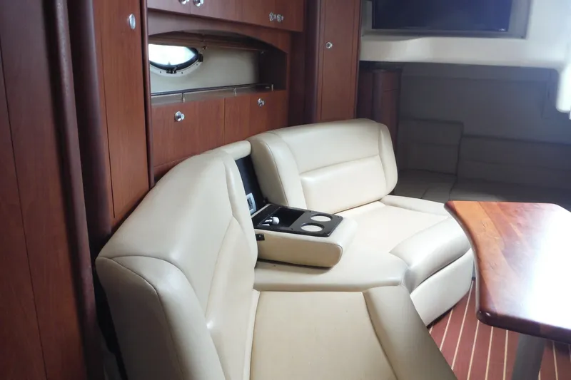 Slide: The Image of Interior of 2007 Monterey 330 Sport Yacht with beige seating and wooden accents. - 24