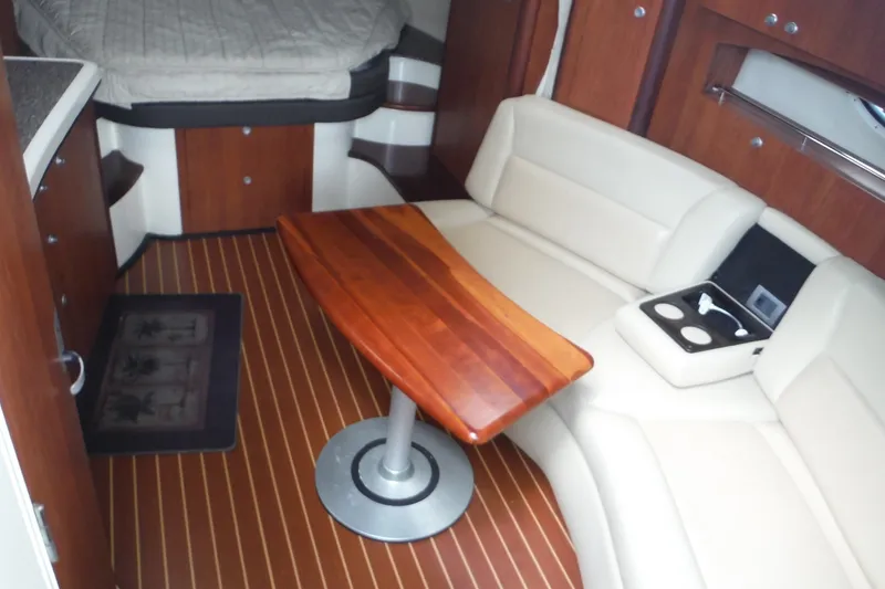 Slide: The Image of Luxurious interior of 2007 Monterey 330 Sport Yacht with wood table and cream seating. - 20