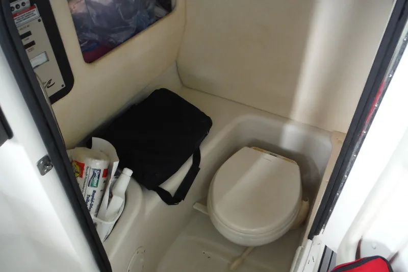 Slide: The Image of Interior of a 2007 Sea Ray 290 SLX boat with a compact toilet area. - 26