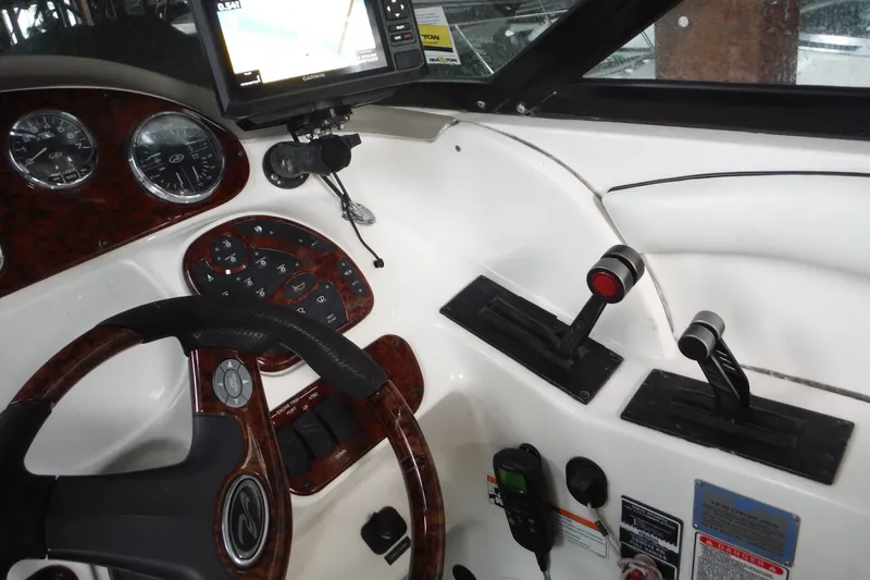 Slide: The Image of 2007 Sea Ray 290 SLX boat dashboard with steering wheel, controls, and Garmin GPS. - 23