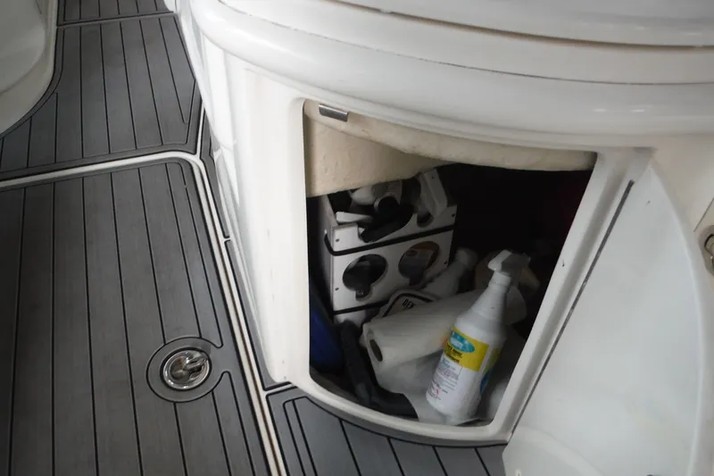 Slide: The Image of Storage compartment on 2007 Sea Ray 290 SLX boat with cleaning supplies and accessories. - 25