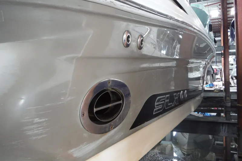 Slide: The Image of 2007 Sea Ray 290 SLX boat hull in storage, showcasing sleek design and branding. - 44