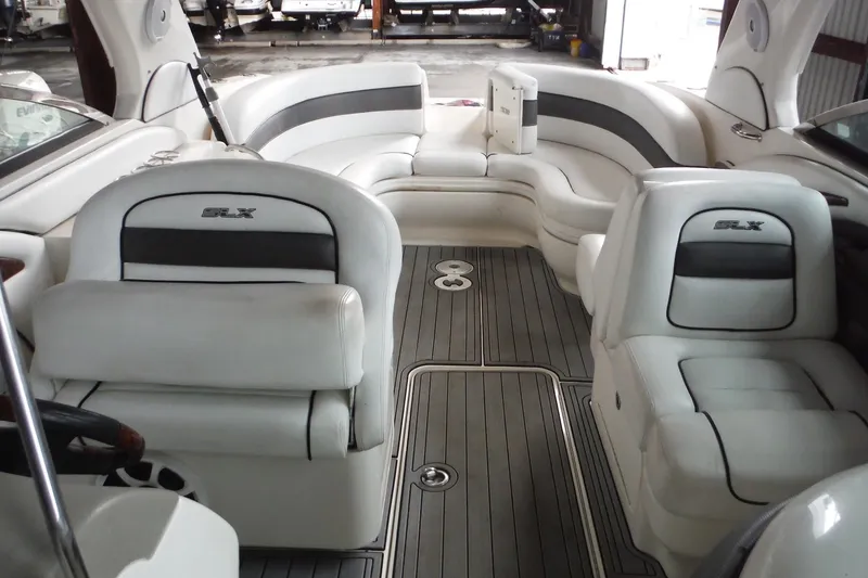 Slide: The Image of Interior of a 2007 Sea Ray 290 SLX boat with white seating and gray flooring. - 18