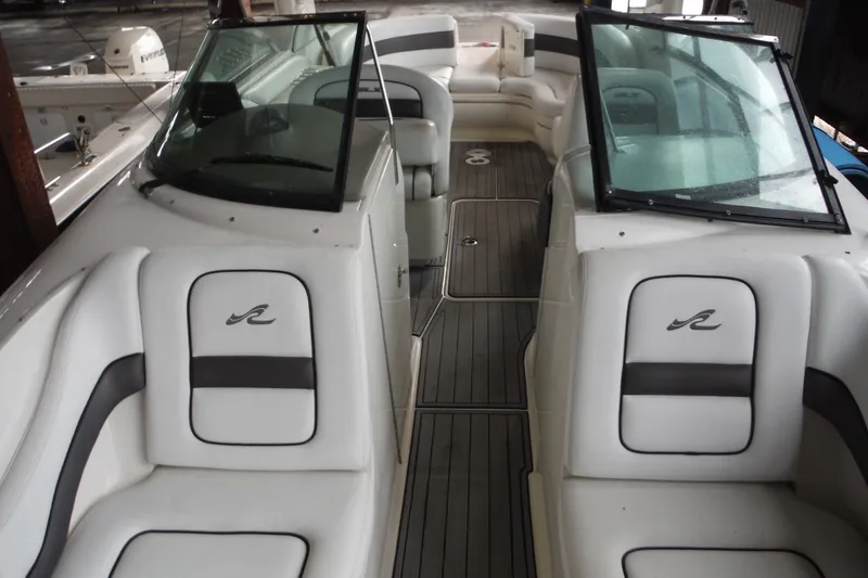 Slide: The Image of 2007 Sea Ray 290 SLX boat interior with white seating and dual windshields. - 17