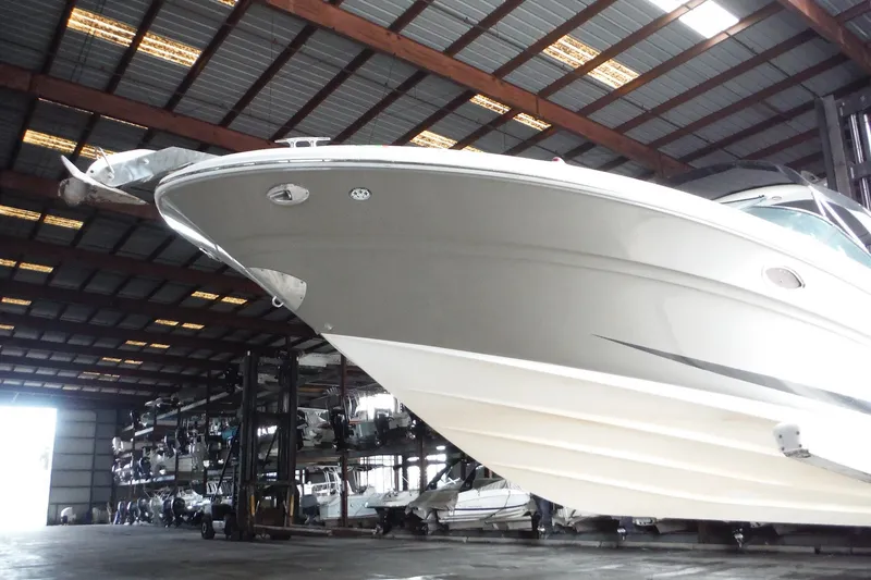Slide: The Image of 2007 Sea Ray 290 SLX boat stored in a spacious indoor facility. - 5