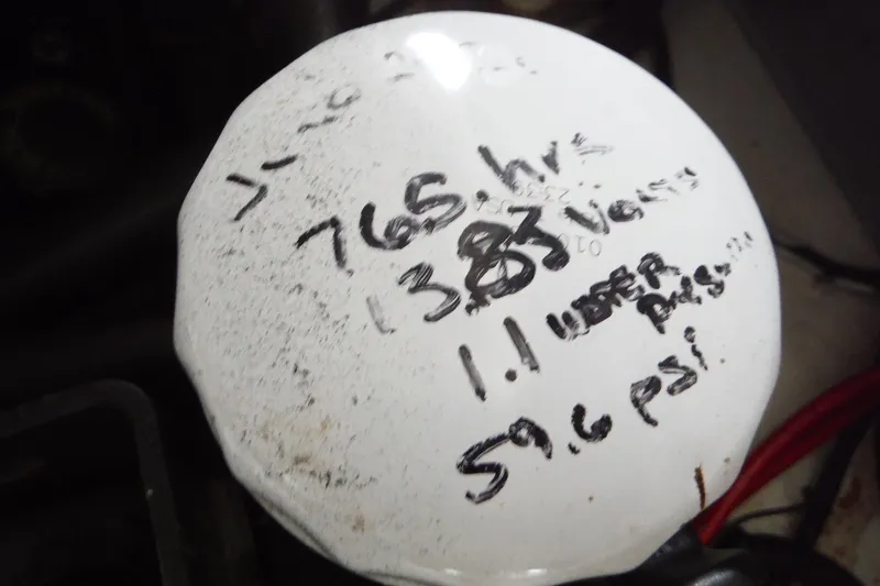 Slide: The Image of 2007 Sea Ray 290 SLX engine part with handwritten maintenance notes. - 34