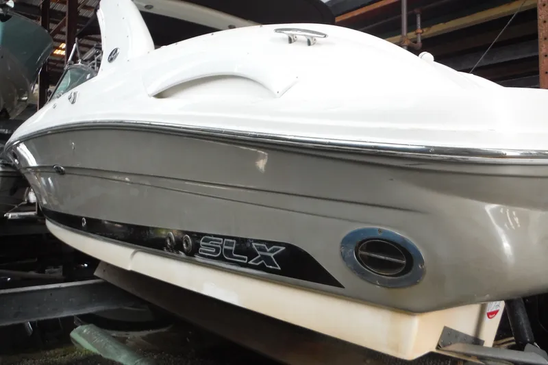 Slide: The Image of 2007 Sea Ray 290 SLX boat in storage, showcasing sleek design and branding. - 45