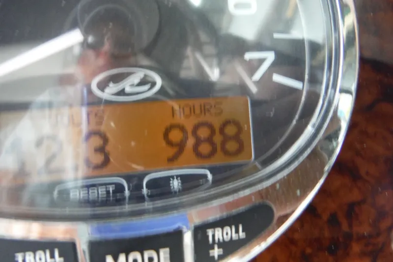 Slide: The Image of Close-up of a 2007 Sea Ray 290 SLX boat dashboard showing 988 hours. - 29