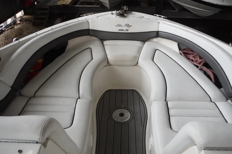 Slide: The Image of 2007 Sea Ray 290 SLX boat interior with white cushioned seating and gray flooring. - 15
