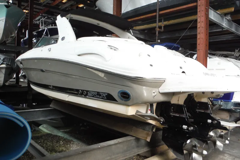 The Image of 2007 Sea Ray 290 SLX boat in storage, showcasing sleek design and powerful engines. - 1