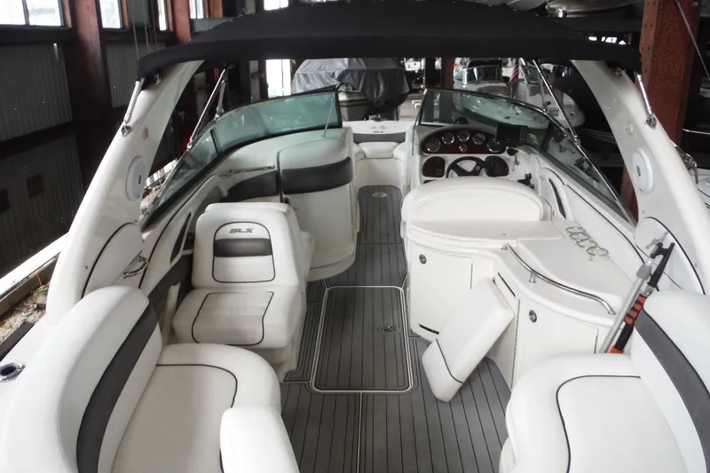 Slide: The Image of 2007 Sea Ray 290 SLX boat interior with white seating and sleek dashboard design. - 9