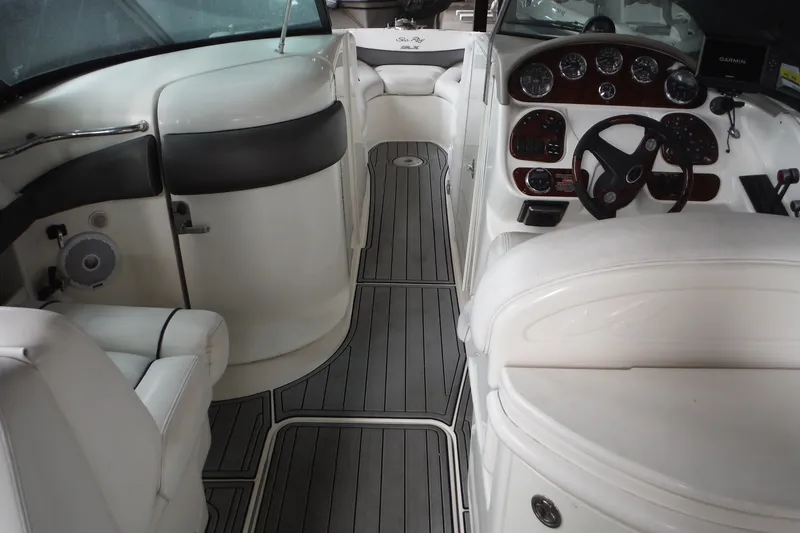 Slide: The Image of 2007 Sea Ray 290 SLX boat interior with white seating and sleek dashboard design. - 12