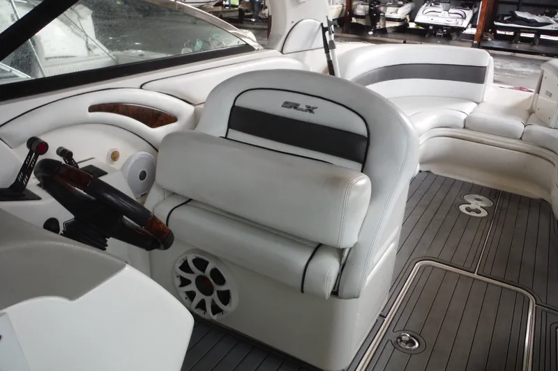 Slide: The Image of Interior of a 2007 Sea Ray 290 SLX boat with white seating and steering wheel. - 20