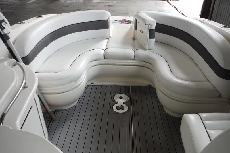 Slide: The Image of Luxurious seating area on a 2007 Sea Ray 290 SLX boat, featuring sleek white upholstery. - 11