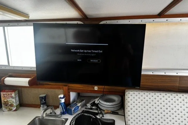 Slide: The Image of 1972 Luhrs 32 Convertible interior with TV showing network setup timeout message. - 14