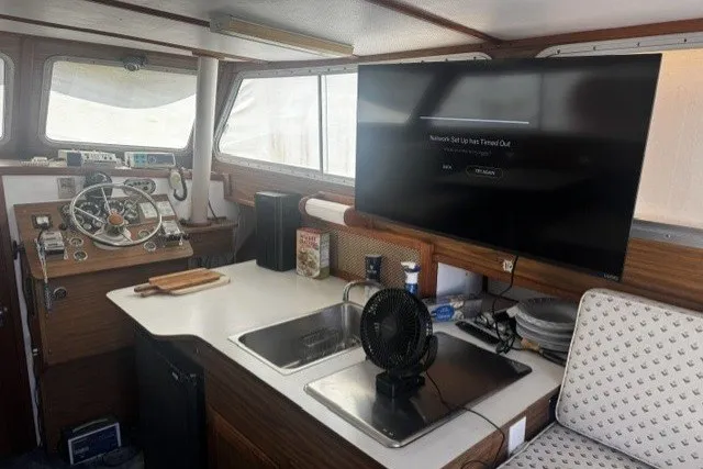 Slide: The Image of Interior of a 1972 Luhrs 32 Convertible boat with helm, sink, and TV. - 5