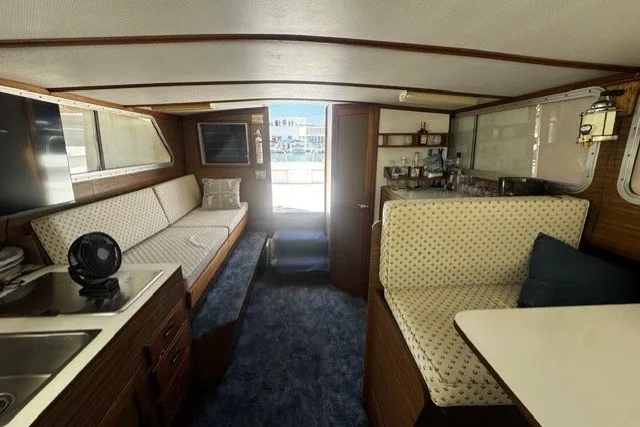 Slide: The Image of Interior of a 1972 Luhrs 32 Convertible boat with seating and kitchenette. - 12