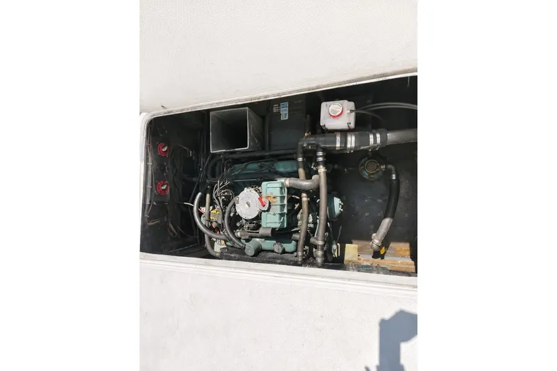 Slide: The Image of Engine compartment of a 1972 Luhrs 32 Convertible boat, showcasing mechanical components. - 17