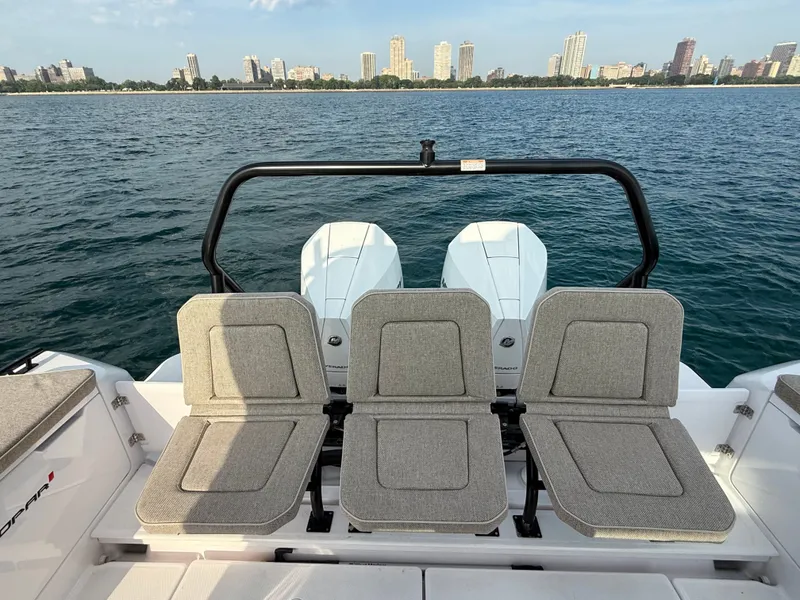 Slide: The Image of Rear view of the Axopar Brabus 37 XC with three seats and two engines, against a city skyline. - 9