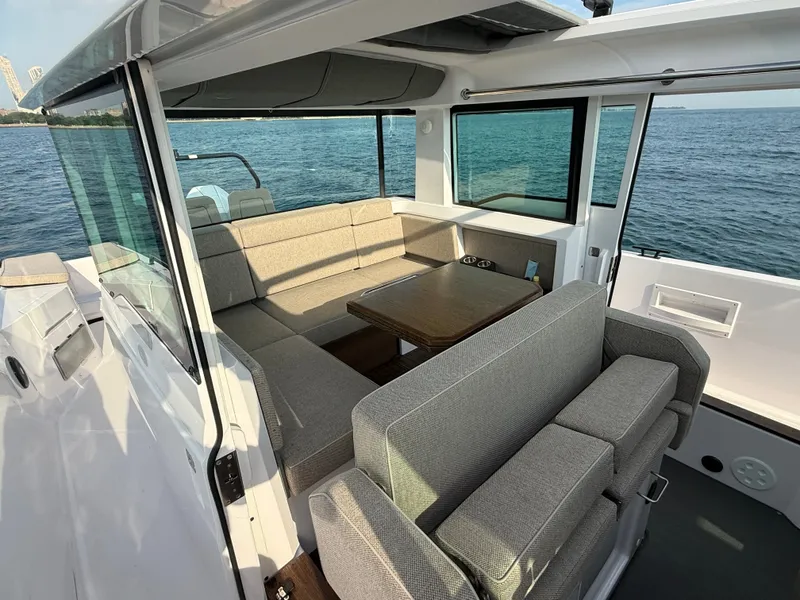 Slide: The Image of The 2023 Axopar Brabus 37 XC Cross Cabin features a stylish seating area with gray upholstery. - 20