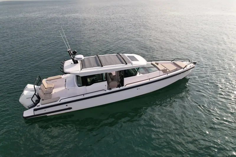 Slide: The Image of A 2023 Axopar Brabus 37 XC Cross Cabin on calm water. - 3