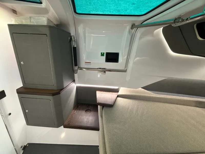Slide: The Image of Interior of the 2023 Axopar Brabus 37 XC Cross Cabin with gray cabinets and seating area. - 29