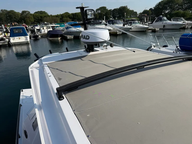 Slide: The Image of The image shows the roof of an Axopar Brabus 37 XC Cross Cabin, surrounded by other boats in a marina. - 41