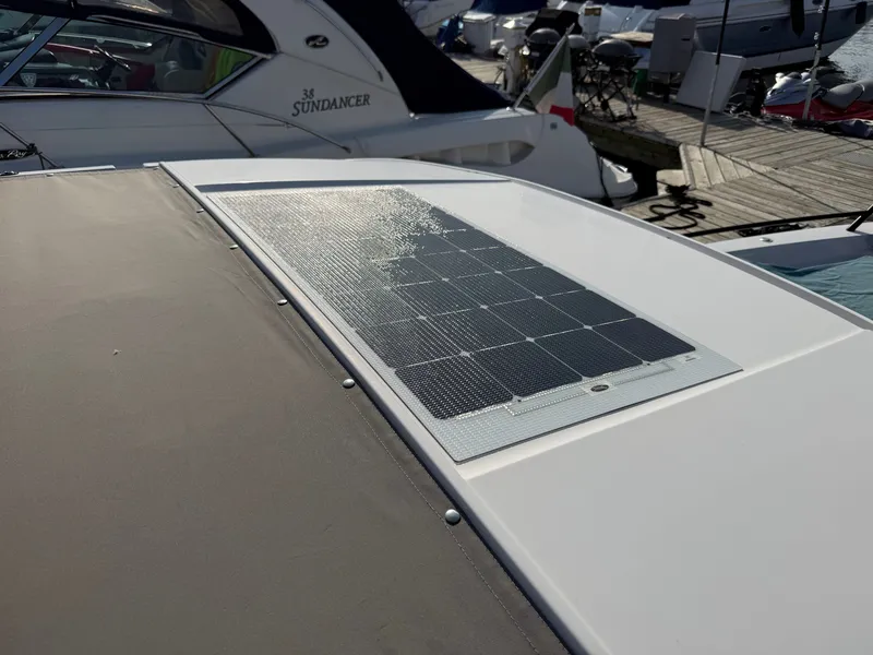 Slide: The Image of The image shows a solar panel on the roof of a boat in a marina. - 42