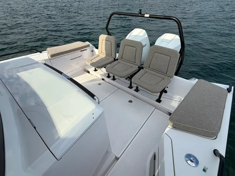 Slide: The Image of The image shows the rear of an Axopar Brabus 37 XC Cross Cabin with three seats and two engines. - 8