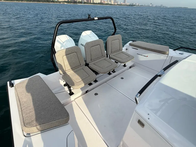 Slide: The Image of The image shows the stern of an Axopar Brabus 37 XC Cross Cabin boat with four seats. - 7