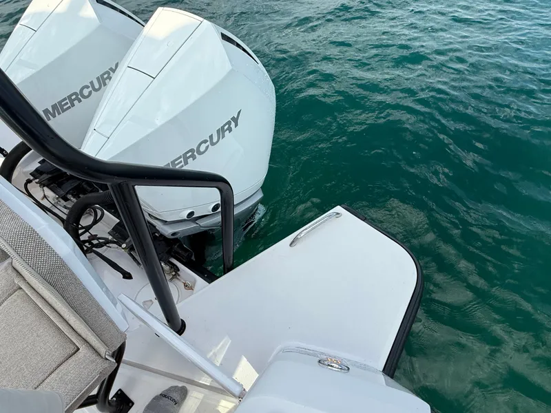 Slide: The Image of Two Mercury outboard engines on a boat in clear water. - 35