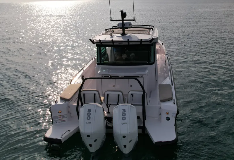 Slide: The Image of The image shows an Axopar Brabus 37 XC Cross Cabin boat from 2023 on calm water. - 4