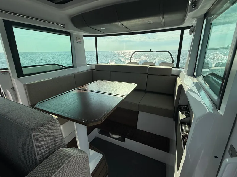 Slide: The Image of Interior of the 2023 Axopar Brabus 37 XC Cross Cabin with seating area and table. - 23