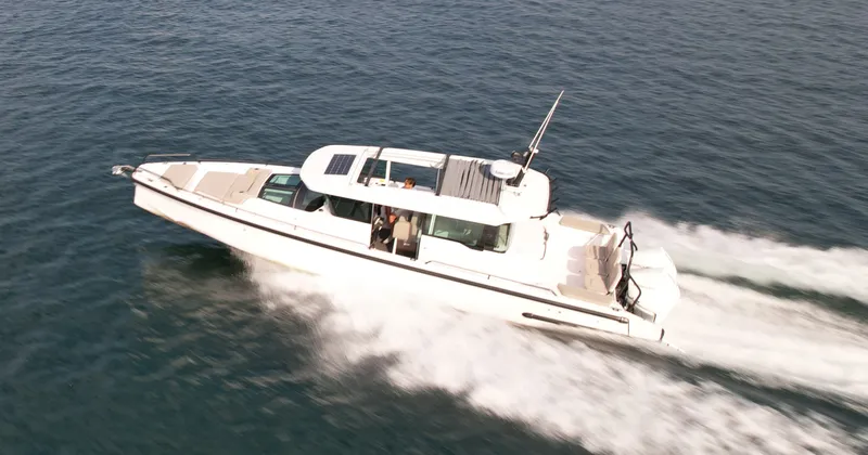 Slide: The Image of 2023 Axopar Brabus 37 XC Cross Cabin cruising on the water. - 6