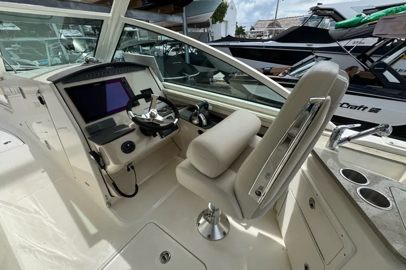 Slide: The Image of 2021 Boston Whaler 320 Vantage helm with modern controls and comfortable seating. - 58