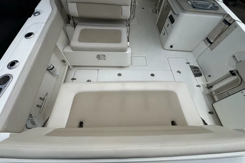 Slide: The Image of 2021 Boston Whaler 320 Vantage interior with beige seating and white deck. - 29