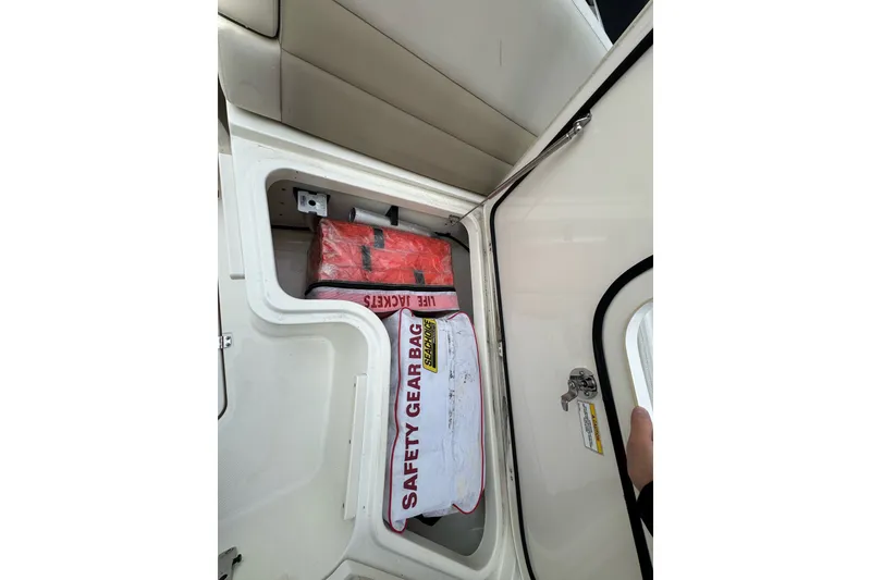 Slide: The Image of Storage compartment with safety gear on a 2021 Boston Whaler 320 Vantage boat. - 89