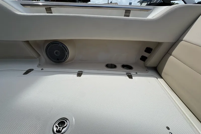 Slide: The Image of 2021 Boston Whaler 320 Vantage interior with speaker and cup holders. - 92