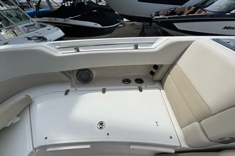 Slide: The Image of 2021 Boston Whaler 320 Vantage interior seating area with cup holders and speaker. - 95